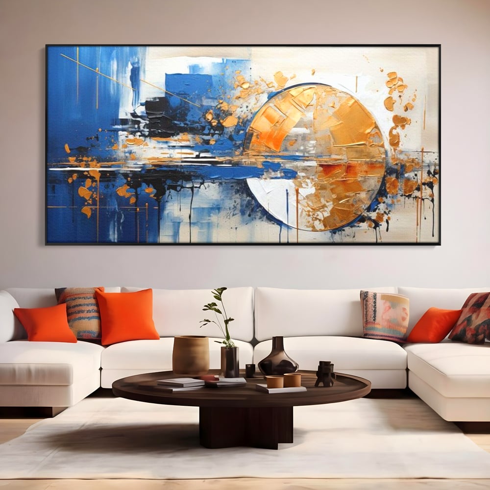 Tablou canvas cu pictura abstracta cu cerc auriu si albastru, in rama de aluminiu negru, pe perete intr-un living
